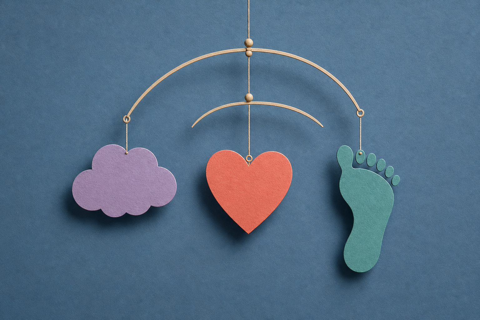 A hanging mobile connects a lavender cloud, coral heart and teal footprint against a muted blue background.